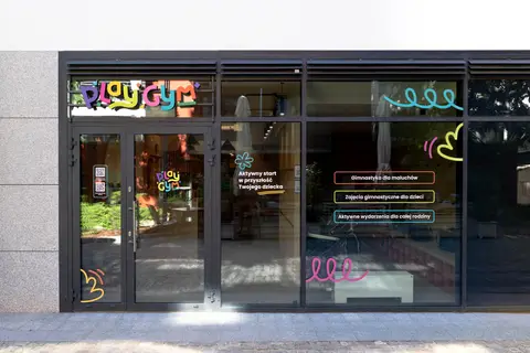 Kolorowe grafiki na witrynie klubu gimnastycznego dla dzieci